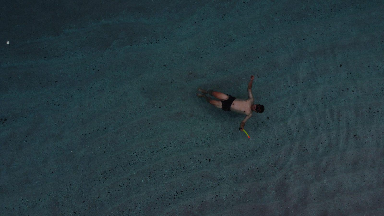 Swim Snorkel – person floating in turquoise water, drone (KEXI 行程实拍)