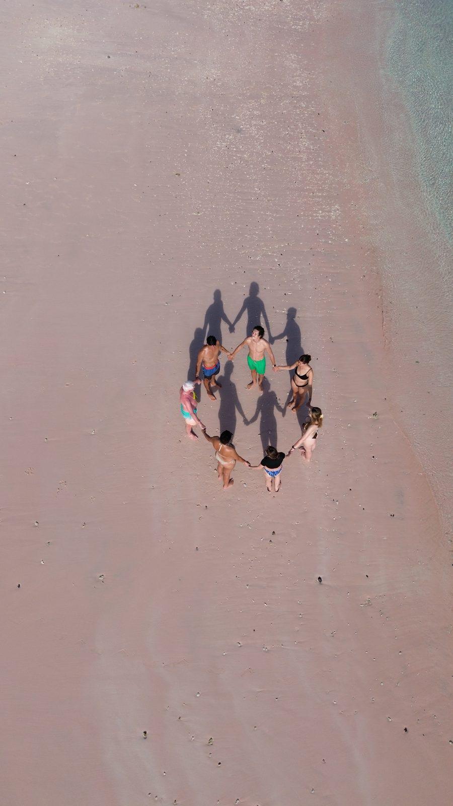 Pink Beach – Aerial group in circle on pink sand (Real photo from a KEXI trip)